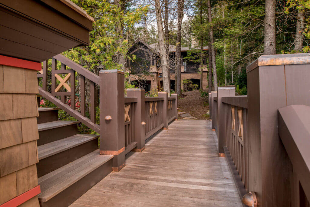 wooden walkway leading to custom designed Adirondack camp