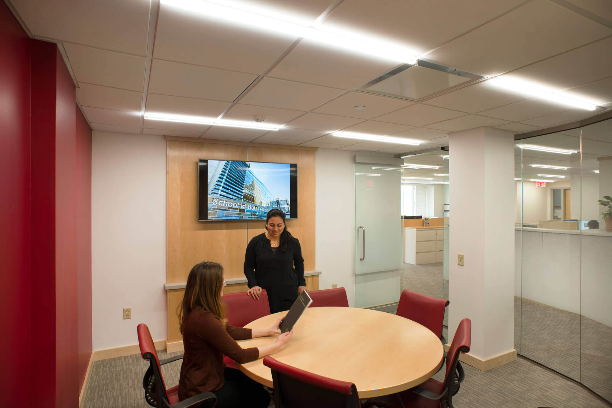 two workers in a deans office meeting room
