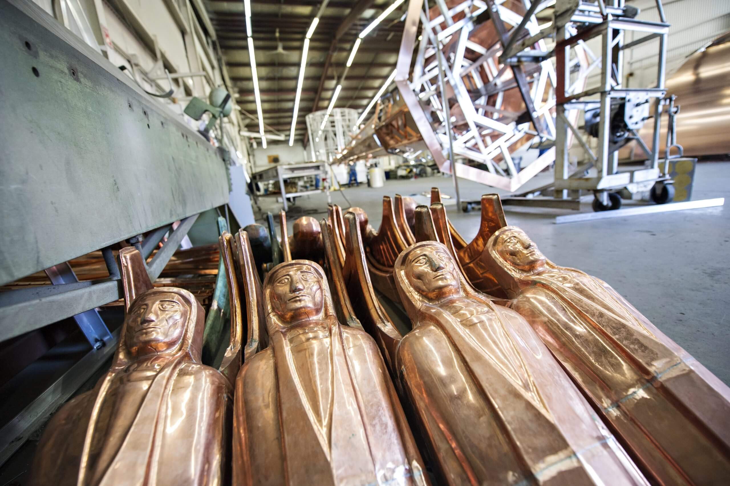 Copper figures stacked, waiting for installation