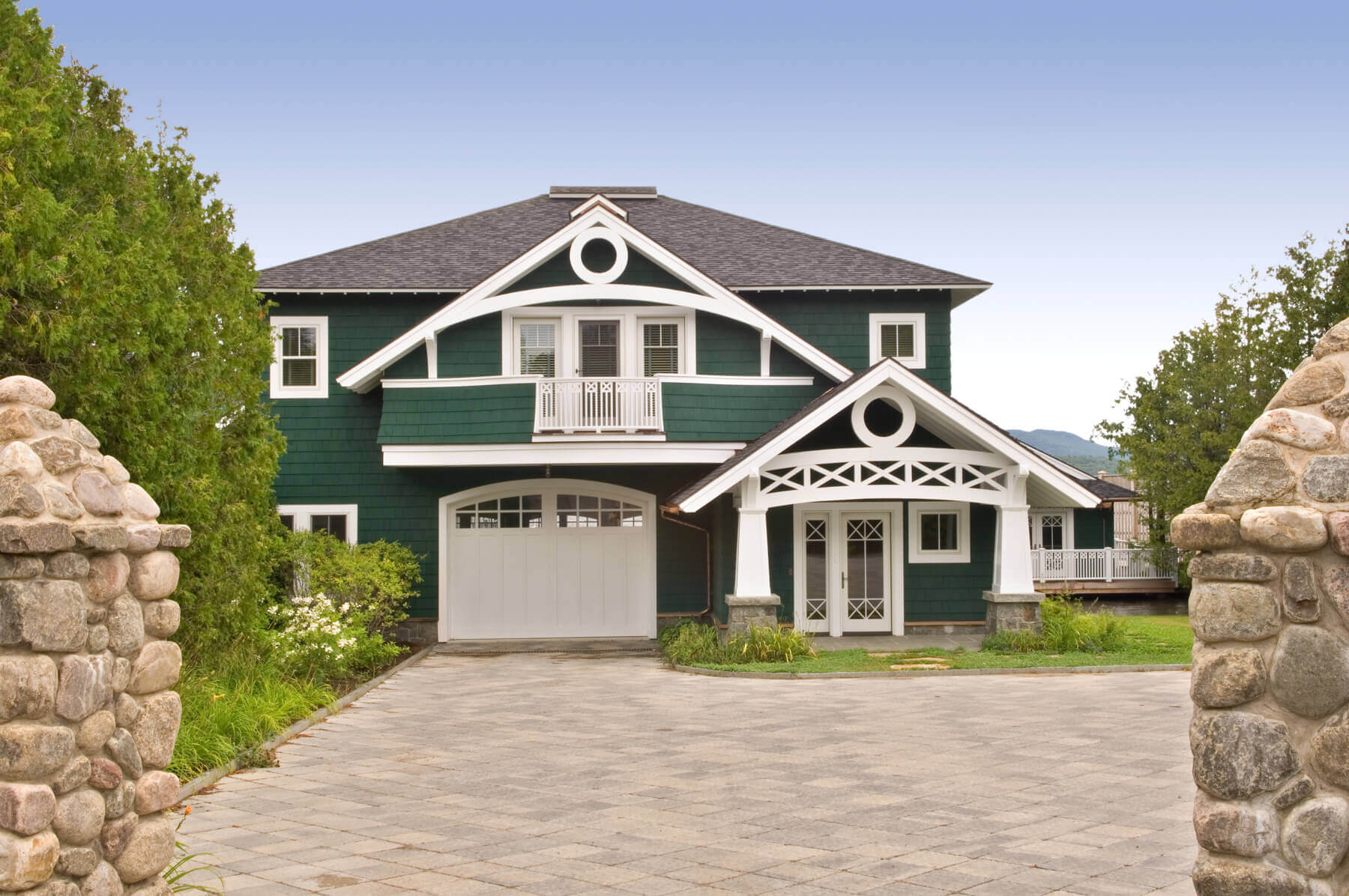 front of architect designed home as seen through stone gate