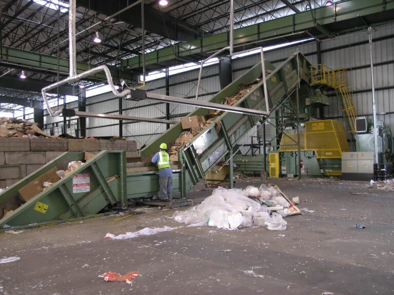Conveyor belt inside recycling plant moving trash