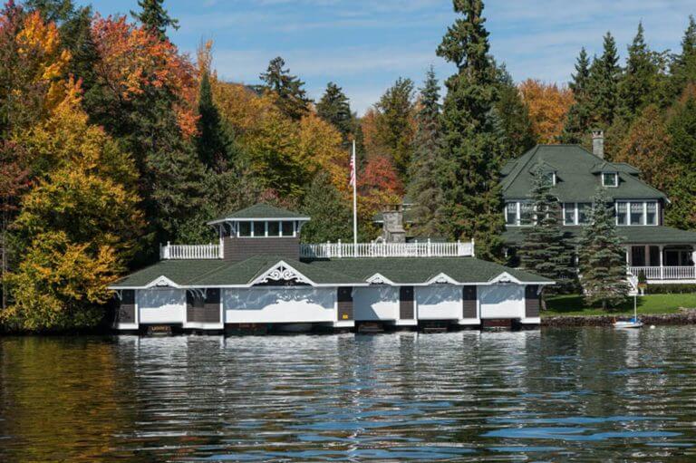 custom lake house with large boathouse on water