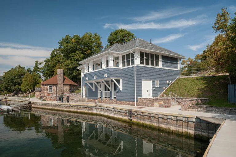 blue shingled marina building with walkway in front