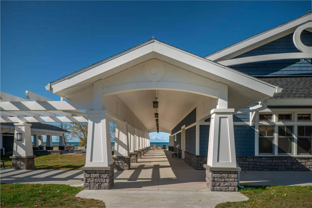 covered walkway with columns with ocean in the background
