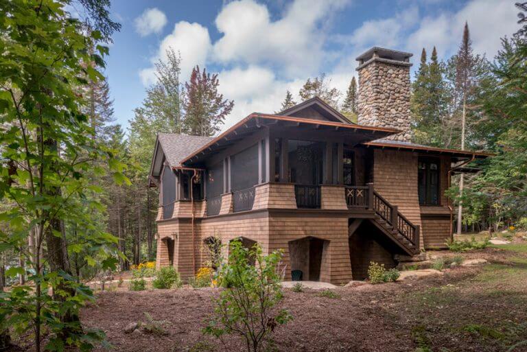 lake house with large stone chimney