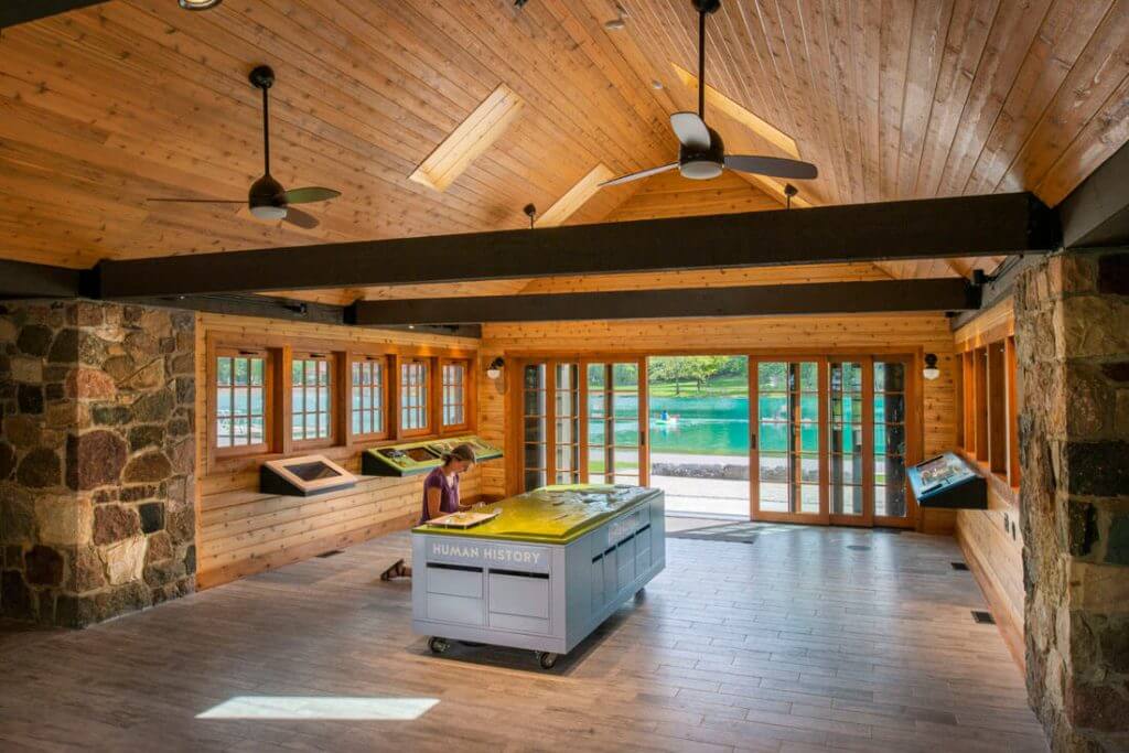 interior of park building with stonework, woodwork, and skylights