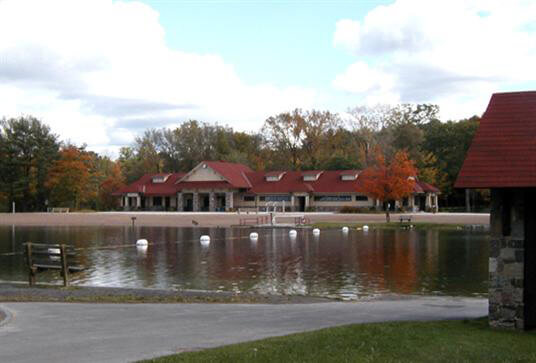 architect designed building viewed across a pond