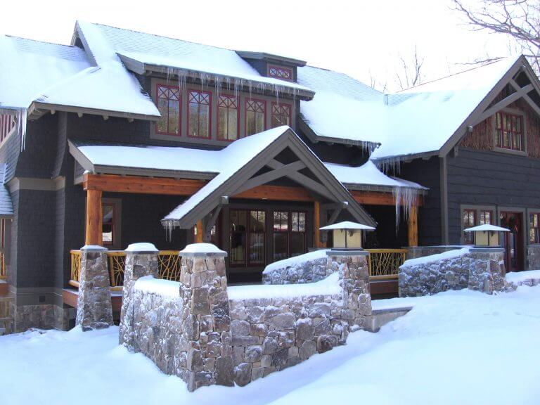 custom stone walls around the entrance of lake house
