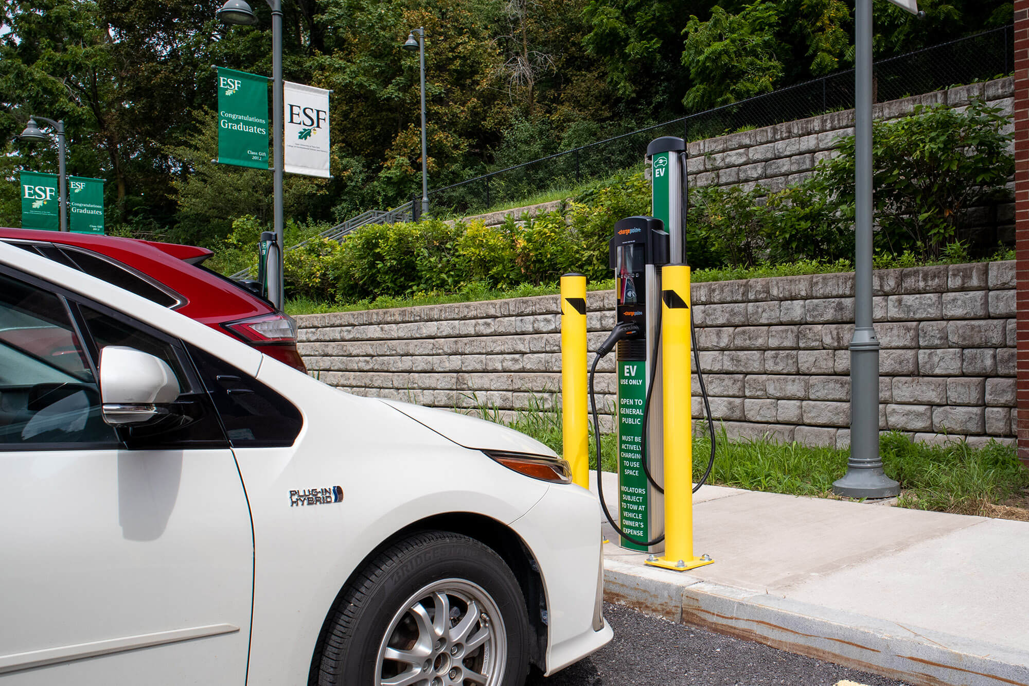 An electric vehicle is parked at an EV charging station