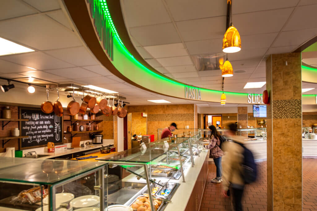 Students make meal selections at the main dining hall serving line