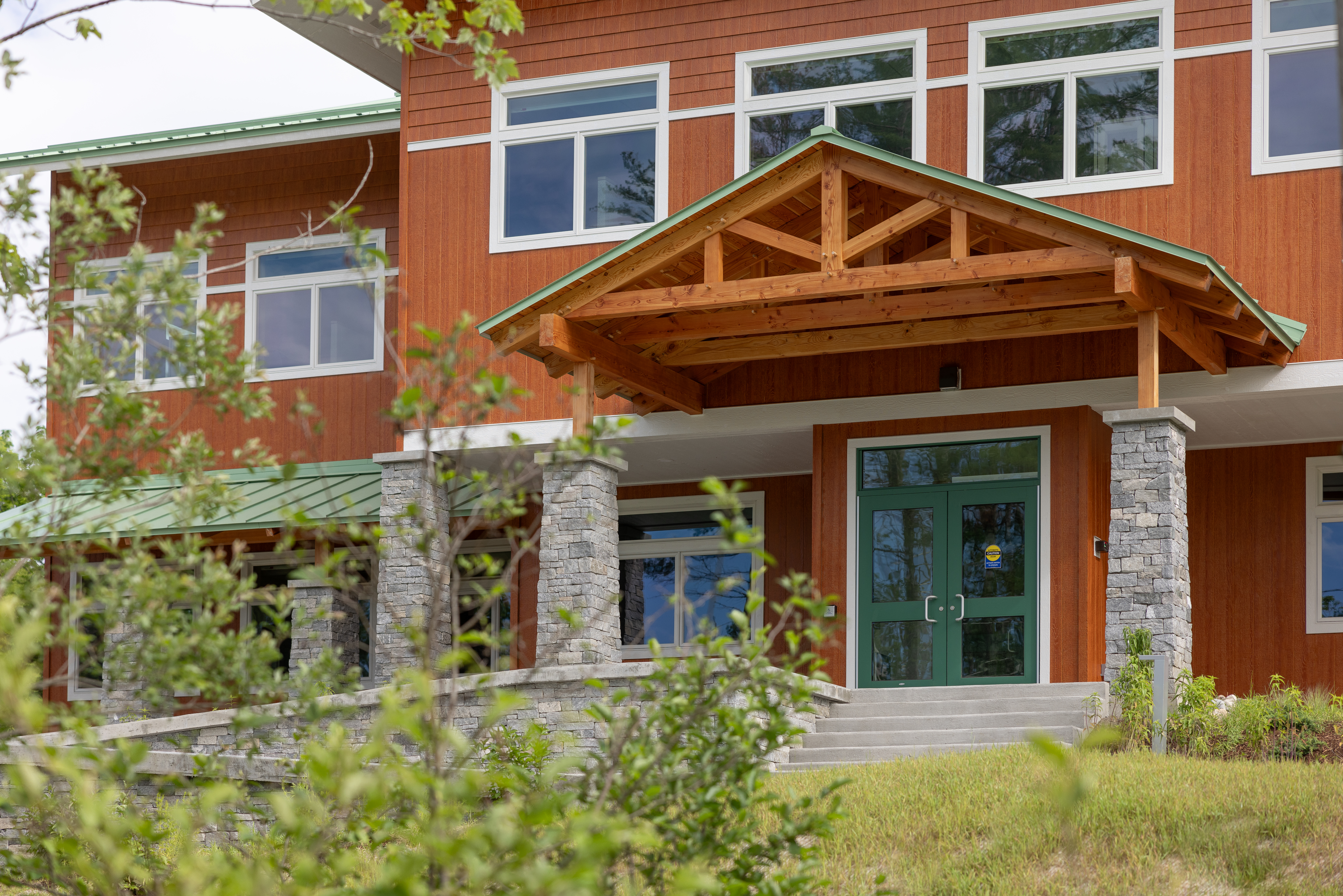 Entrance of the US Forest Service building featuring exposed wood beams and glass doors.