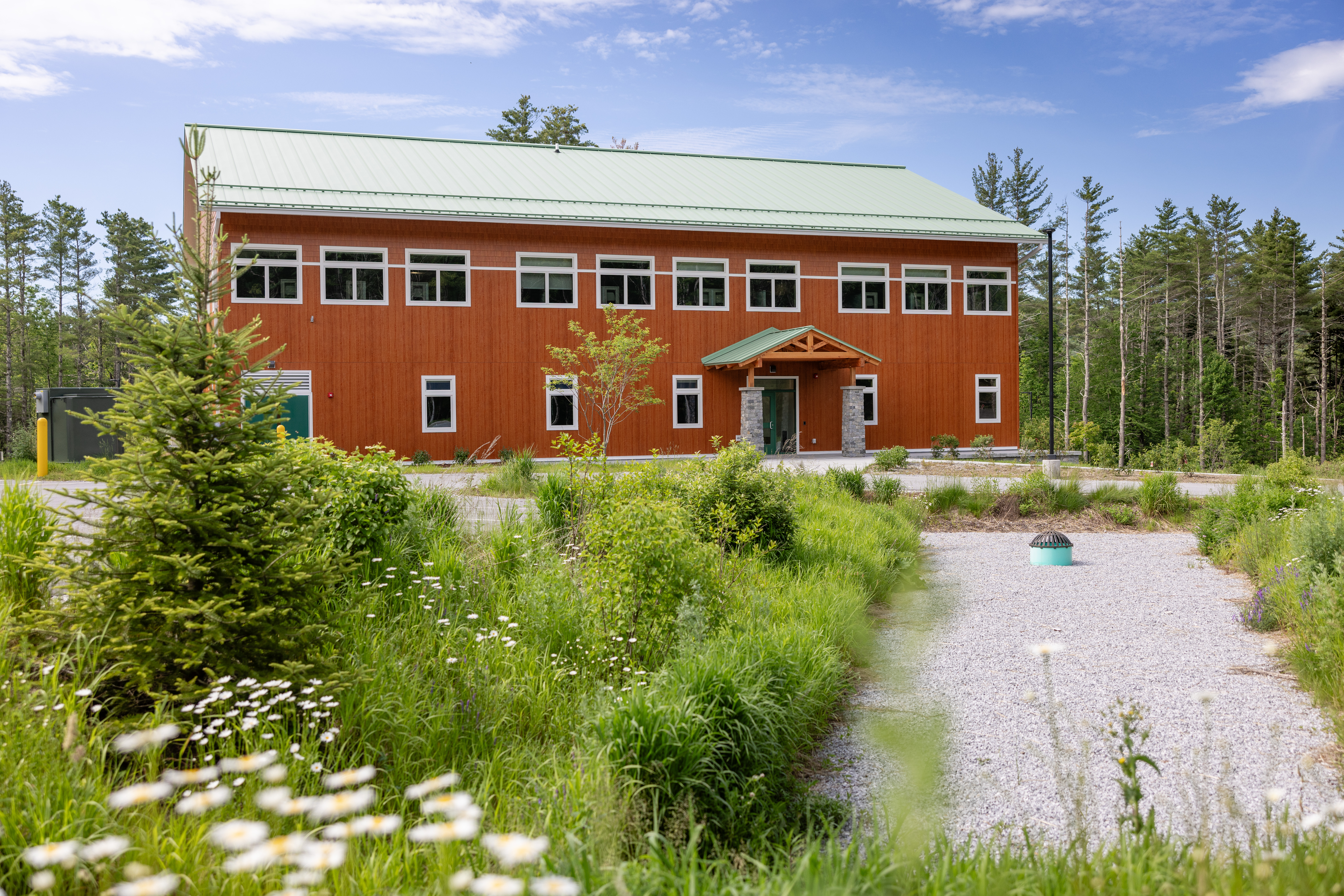 Exterior view of the US Forest Service office building with landscaped entrance and native plantings