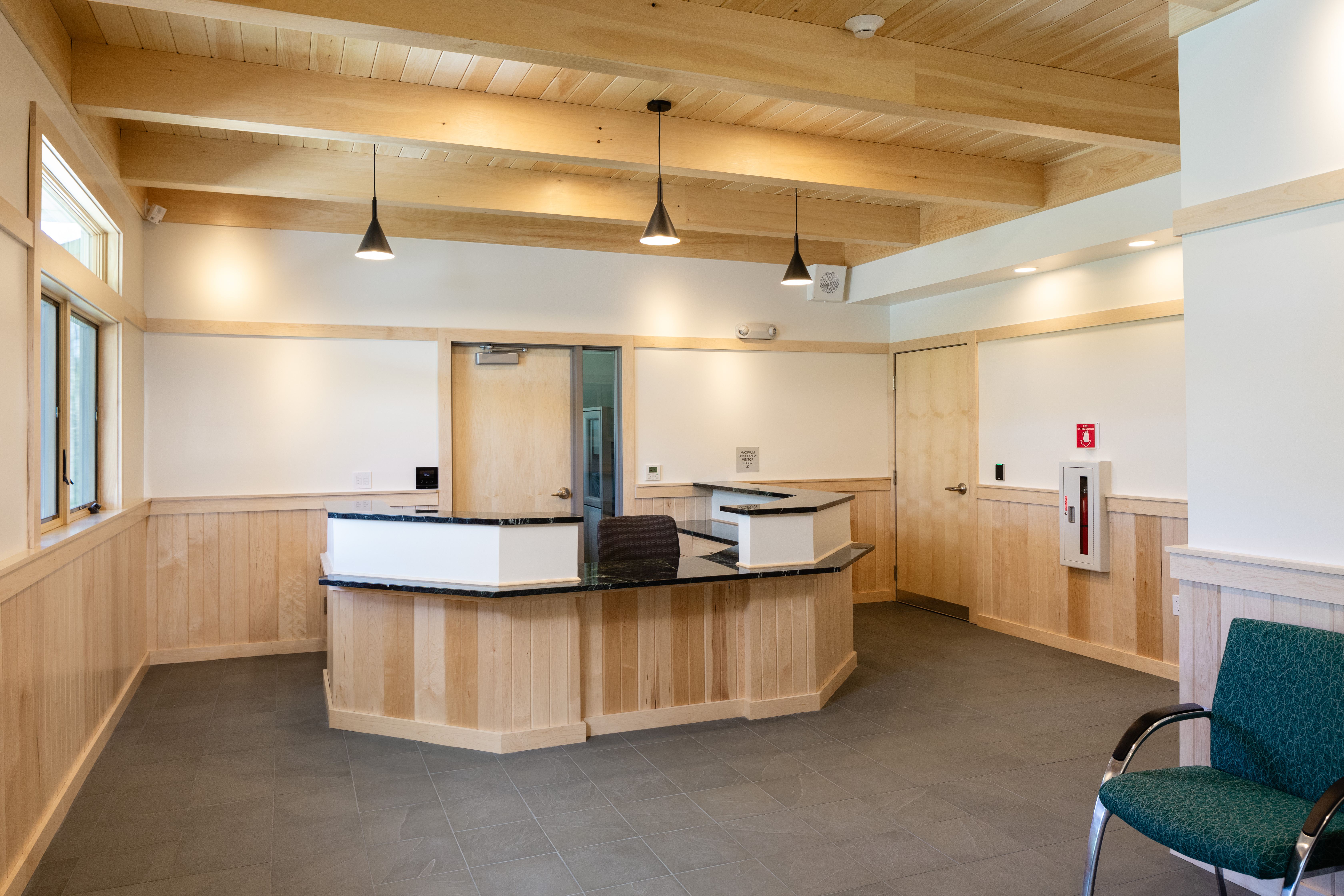 Reception area of the US Forest Service office building with modern desk, visitor seating, and natural light.
