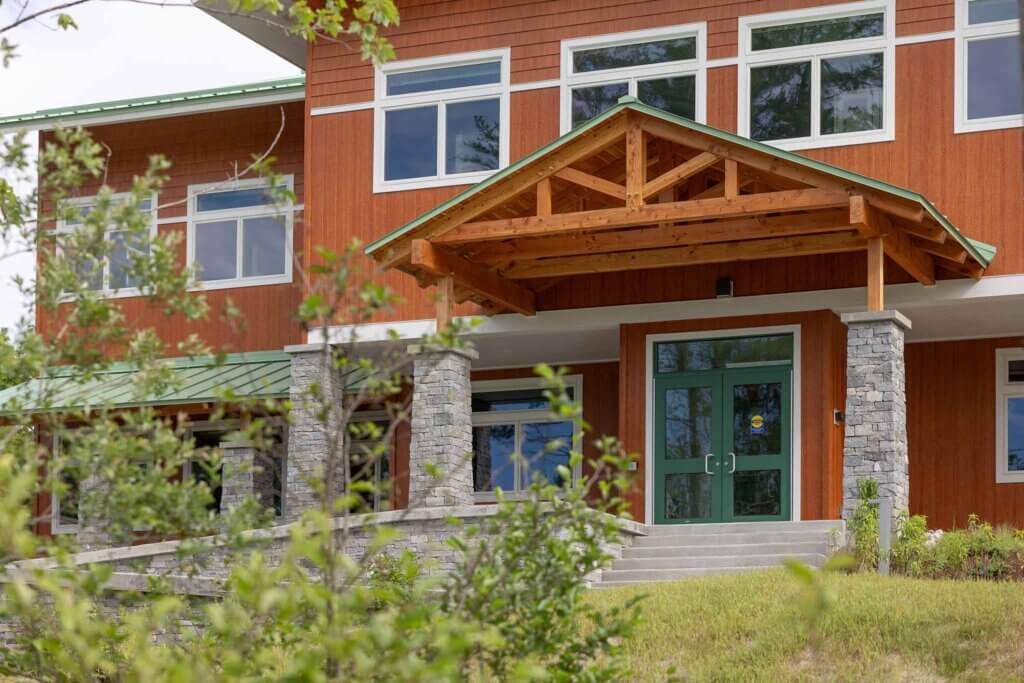 Entrance of the US Forest Service building featuring exposed wood beams and glass doors.